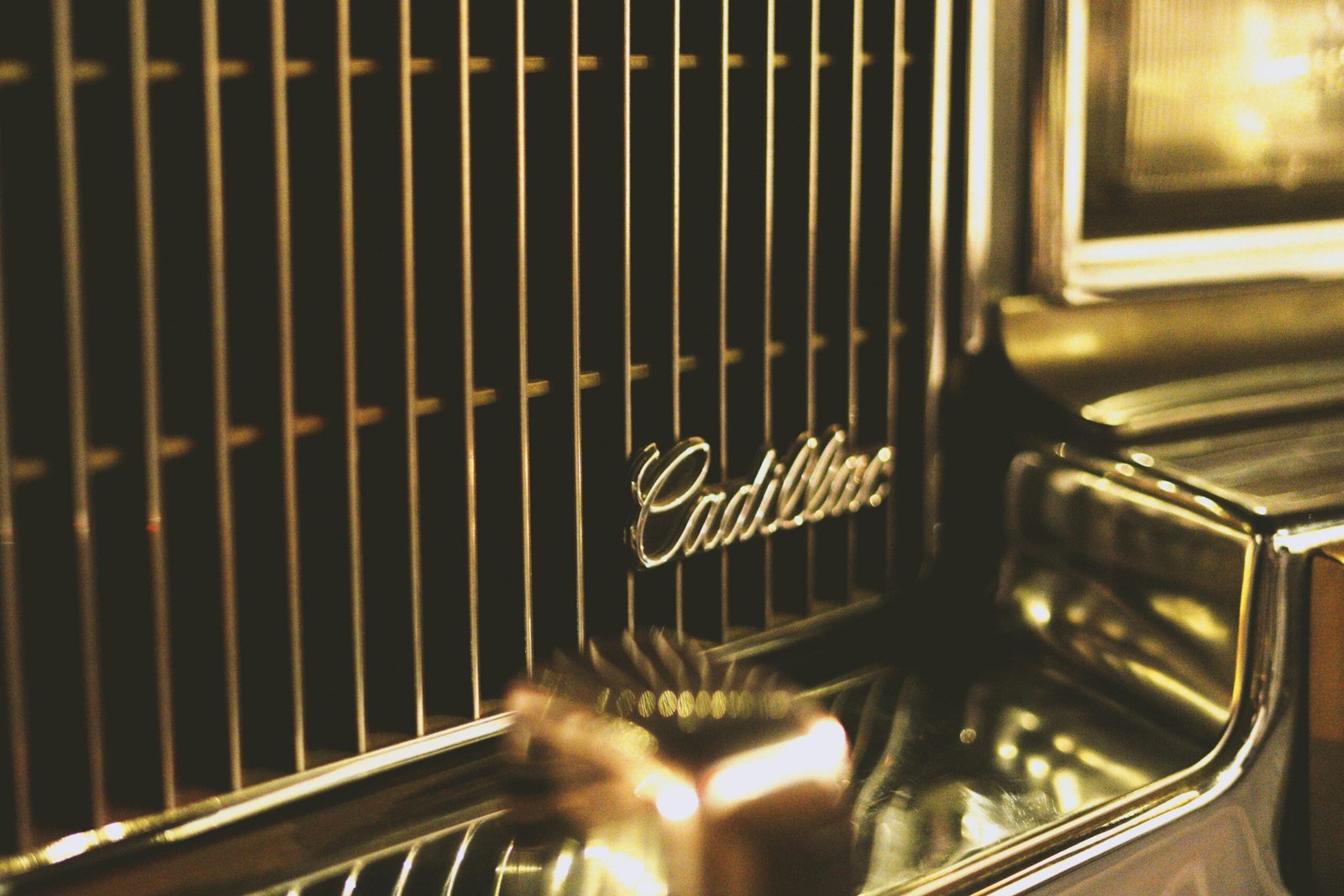 Detailed view of a vintage Cadillac car grill showcasing elegant chrome design.